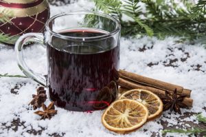 glass with mulled wine in snow background
